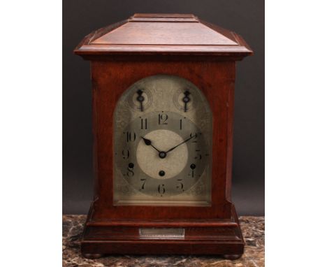 An early 20th century oak musical bracket clock, 17cm arched silvered dial inscribed with Arabic numerals, Slow/Fast and Chim