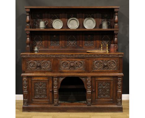 A 17th century style oak country house buffet side cabinet, panelled back with rectangular shelf, the projecting base with th