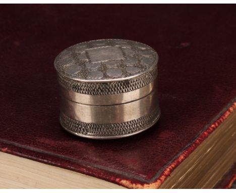 A George III silver circular pill box or bonbonniere, push-fitting cover, bright-cut engraved with wrigglework, 2.5cm diam, m