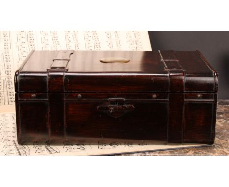 An unusual stained beechwood rectangular desk box, carved as a leather bound coaching trunk, the hinged cover with vacant bra
