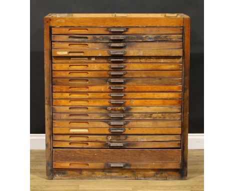 An early to mid-20th century oak primary printer’s or draughtsman’s plan chest, now fitted for the horologist, containing var