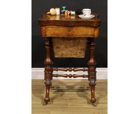 A Victorian burr walnut serpentine combination games and work table, hinged top, the interior inlaid for chess, backgammon an