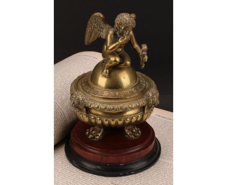 A 19th century post regency stop fluted campana shaped inkwell and cover, cast with a seated cherub above egg and dart border