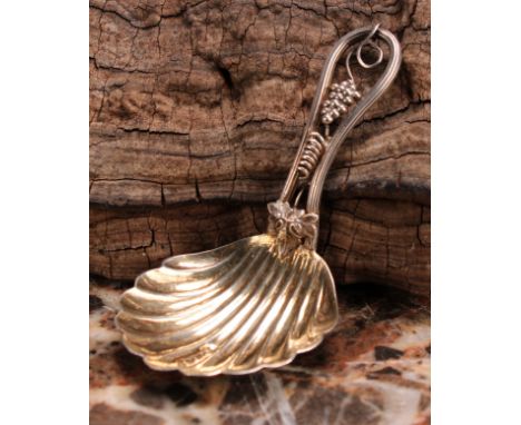 A Victorian silver caddy spoon, shell bowl, the stem with fruiting vine, 7.5cm long, George Unite, Birmingham 1869 