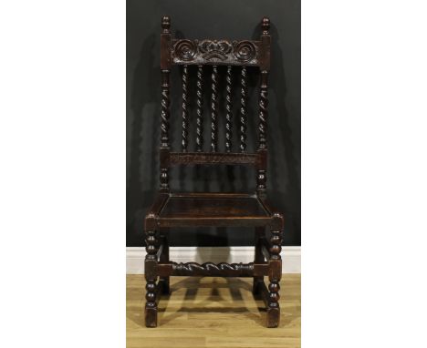 A Charles II oak side chair, curved cresting rail carved with a crown, above a row of spirally-turned supports, panel seat, b