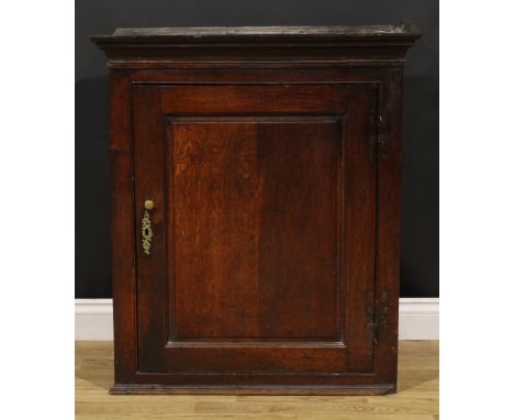 A George III oak wall hanging provision cupboard, raised and fielded panel door enclosing a shelf and three spice drawers, 93