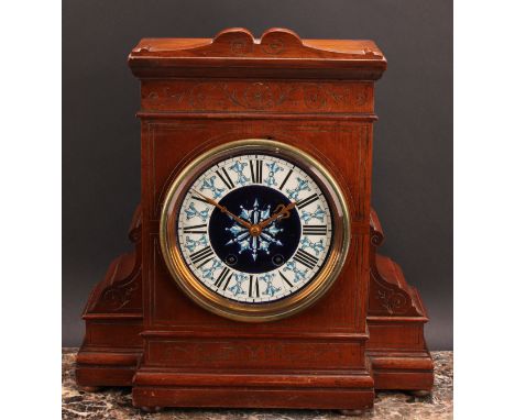 An Aesthetic Movement oak mantel clock, 15cm circular ceramic dial inscribed J Maple &amp; Co, London &amp; Paris, twin windi