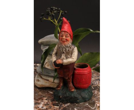 An Austrian terracotta gnome, by Johann Maresch, he stands, playing bowls, 23cm high, impressed marks, no.6912, c.1890 