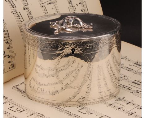 A George III silver oval tea caddy, flush-hinged cover with leafy branch finial, bright-cut engraved borders and vacant carto