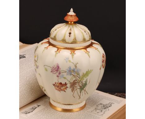 A Royal Worcester lobed ovoid pot pourri vase and cover, painted with flowers on an ivory ground, picked out in gilt, pierced