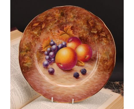 An English porcelain shaped circular plate, painted by N. Creed, signed, previously a painter with Royal Worcester, with peac