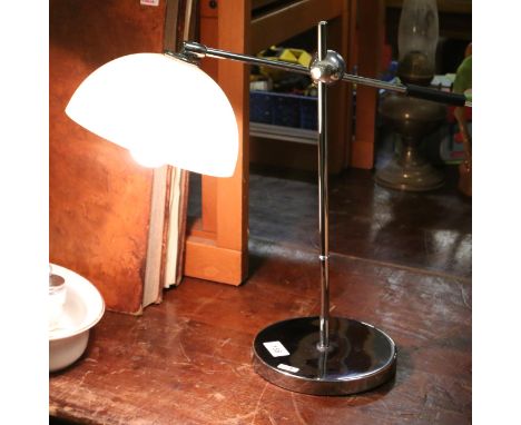A chrome adjustable reading lamp.