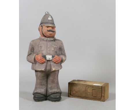 An abstract puzzle box along with a Walters palm toffee storage container circa 1938 in the shape and style of a Police Offic