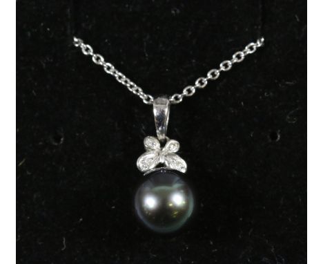 An 18ct white gold necklace and pendant set with a black pearl and diamonds.