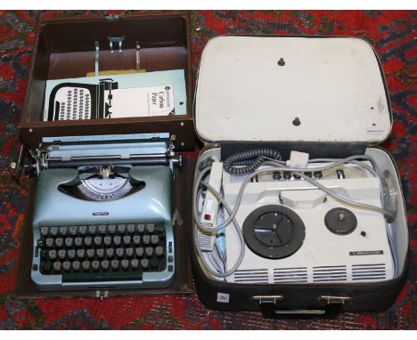 A vintage typewriter in leather carrier along with a reel to reel microphone recording unit.