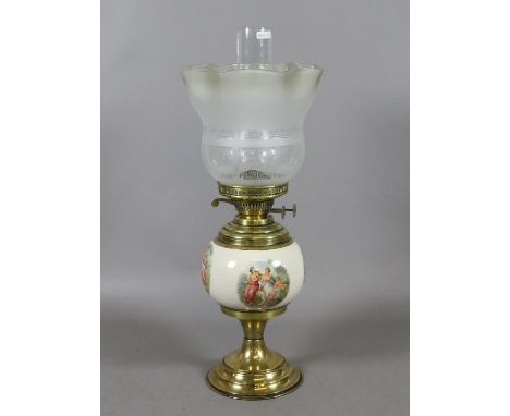 A brass based oil lamp with ceramic font decorated with semi naked woman and cherubs with etched glass shade.