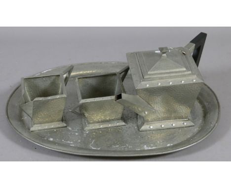 An Art Deco four piece English pewter tea service with planished decoration.