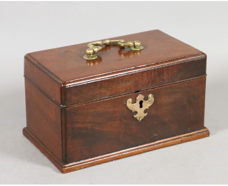 A George III mahogany tea caddy with brass handle and escutcheon having three compartments and raised on a moulded plinth.