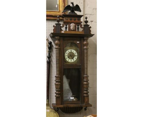 A Victorian Vienna Springer wall clock with enamel and brass dial chiming on a coiled gong.