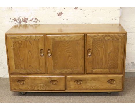 An Ercol Golden Dawn three door sideboard.