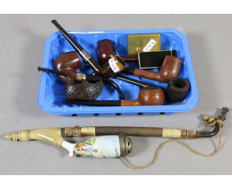 A collection of old smoking pipes to include Holland ceramic bowl and carved clog example, along with Zippo lighters and one 