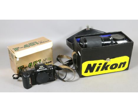 A boxed Nikon F-401 camera body along with a case containing 200m lenses and flash gun.