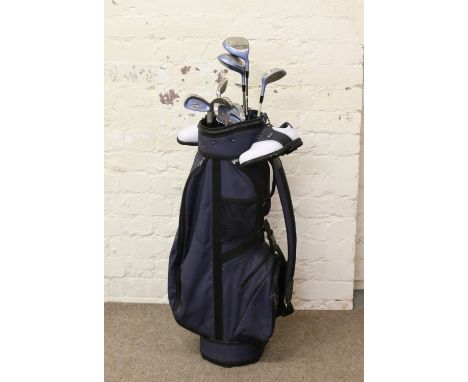 A set of Wilson offset design golf clubs in caddy bag along with a ladies pair of size 5 Dunlop shoes in unworn condition.