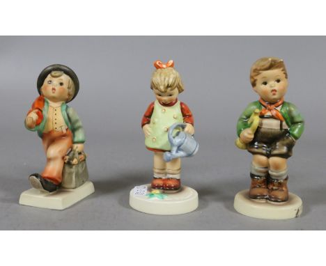 Three Goebel figures by M J Hummel entitled 'Little Gardener', 'Merry Wanderer' and 'Trumpet Boy'.