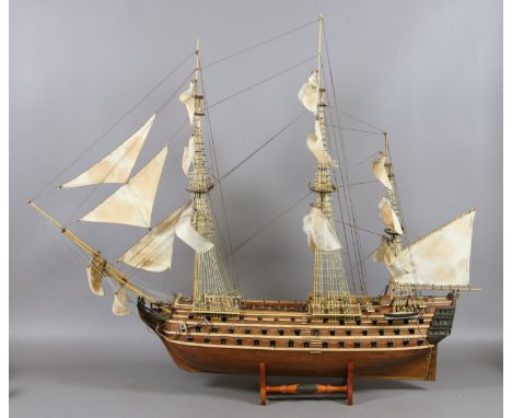 A scale model on stand of H.M.S Victory 1765. Kit built from wood, 95cm bow to stern.