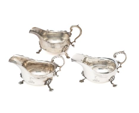 THREE GEORGE V SILVER SAUCEBOATS, LONDON, 1911, in typical Georgian style with three shell headed feet, a pair engraved with 