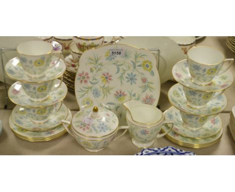 A Minton Vanessa pattern tea set, printed with flowers, comprising six tea cups, saucers and tea plates, sandwich plate, milk