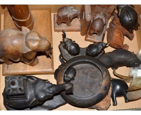 A lamp base carved with a model elephant;  a pair of Indian elephant bookends;  other carved elephant models;  a horn bird 
