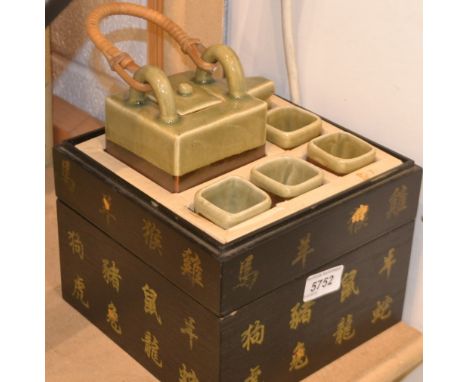 A Japanese hot saki set comprising  saki, pot and 5 square cups in original box