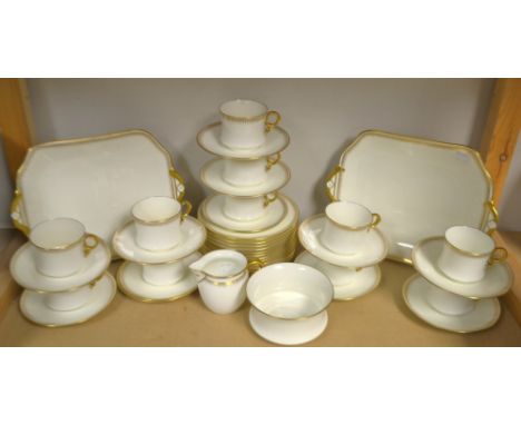 A Cauldon cream ground with a gilt edge tea service, comprising cake plates, side plates, cups and saucers, cream jug and sug