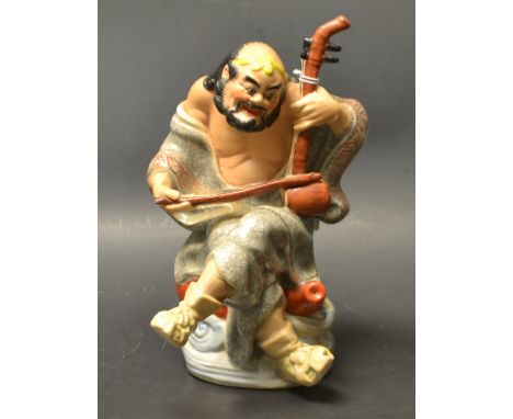 A Japanese figure, immortal playing an instrument