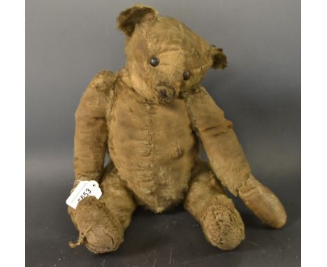 A Steiff mohair teddy bear, jointed, small cupped ears, black boot button eyes, stitched snout, each paw with four black stit