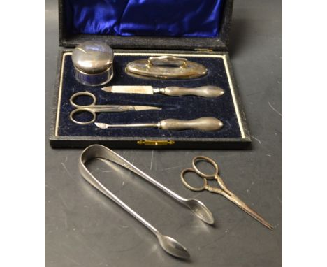 Silver - A four piece manicure set, comprising nail buffer, file, cuticle tool and lidded glass jar, Birmingham 1920, cased w