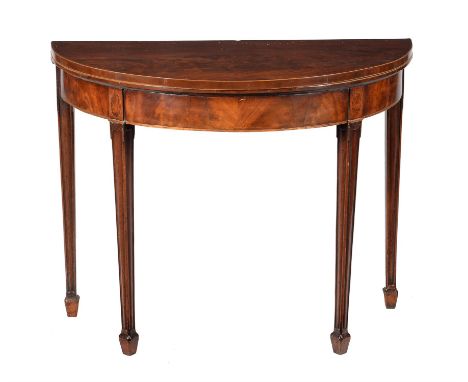 A George III mahogany folding card table, circa 1790, of semi-eliptical outline, with moulded square section legs terminating