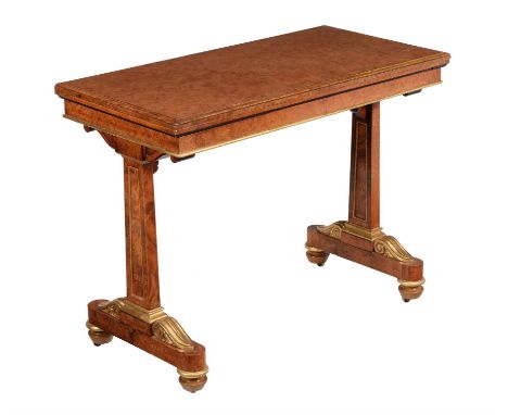 A Regency amboyna and parcel gilt card table, circa 1815, in the manner of George Seddon, the hinged rectangular top revolvin