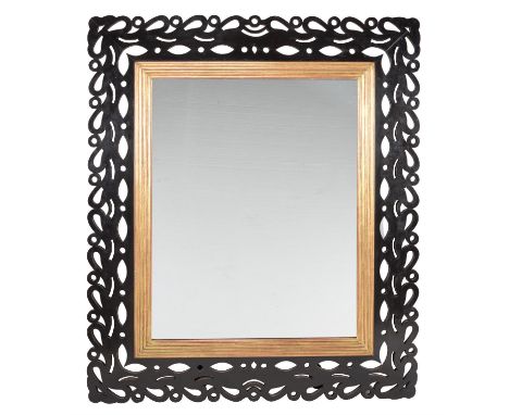 An Italian rectangular wall mirror, late 19th century, with pierced ebonised walnut frame and reeded giltwood slip, 138cm hig