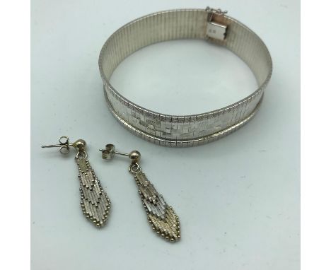 A Silver Art Deco style bangle with silver Art Deco style earrings 