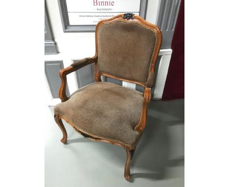 A reproduction bedroom carver chair styled in leopard print material. 