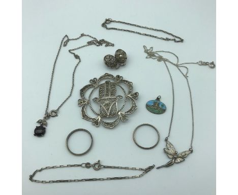 A selection of silver jewellery to include; two sterling silver and 1/10th of 14kt gold band rings, filigree silver pendant &