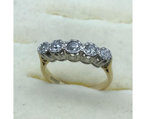 An 18ct gold and Platinum ring set with 5 Diamonds. Size F. 