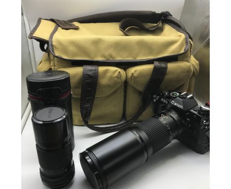 Canon AE-1 Program camera with Tokina 400mm lens, Canon Lens FD 200mm lens and carry bag. 