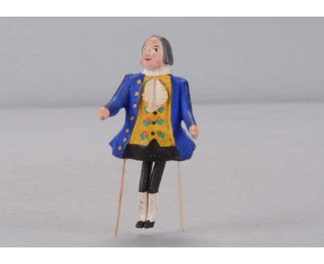 A late 19th century German bristle dancing 18th century gentleman toy,  with grey painted ‘wig’, blue tailcoat, yellow with m