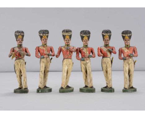 Six early 19th century carved wooden British Napoleonic era military bandsmen,  with moustaches, hair brushed onto the face, 