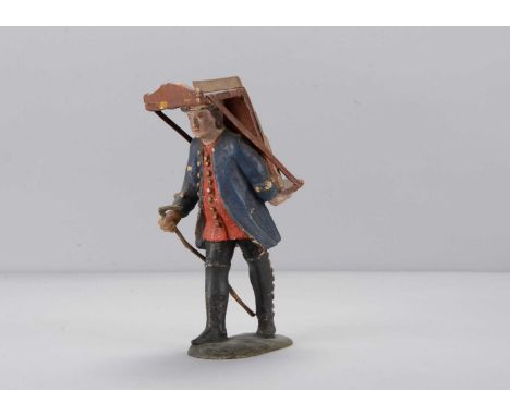 An early 19th century Oberammergau carved wooden travelling icon salesman, finely carved features, blue frock coat and red wa