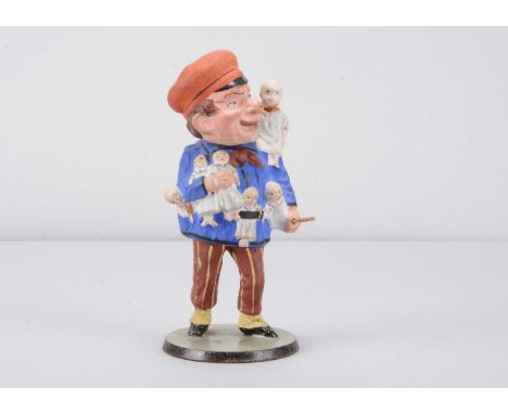 A mid to late 19th century baby deliverer (Kinderbringer) or doll seller nodder, with red painted and moulded cape, blue tuni