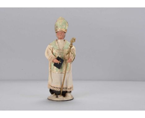 An early 20th century Bishop candy or sweet container,  with composition head with grey painted hair and moustache and hands,